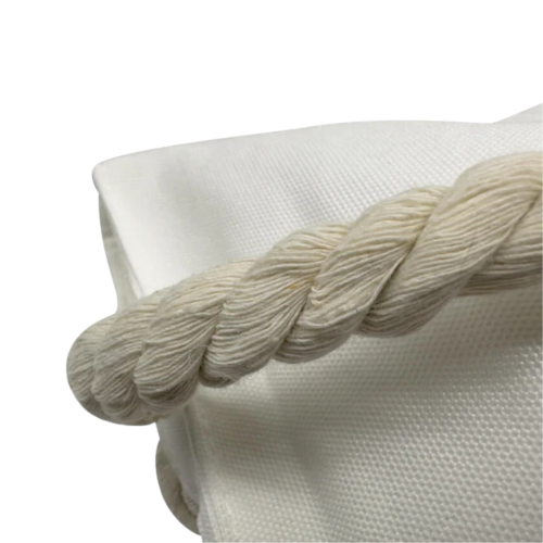 Close-up of a braided rope on a textured white surface