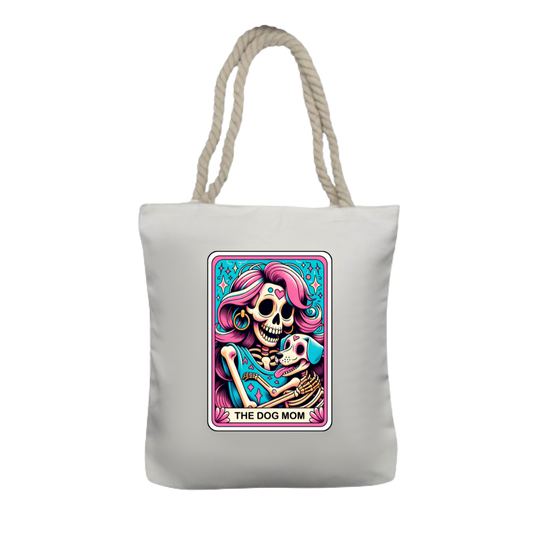 A white polyester tote bag with thick twisted rope handles, featuring a colorful tarot card style design with a skull and a dog.