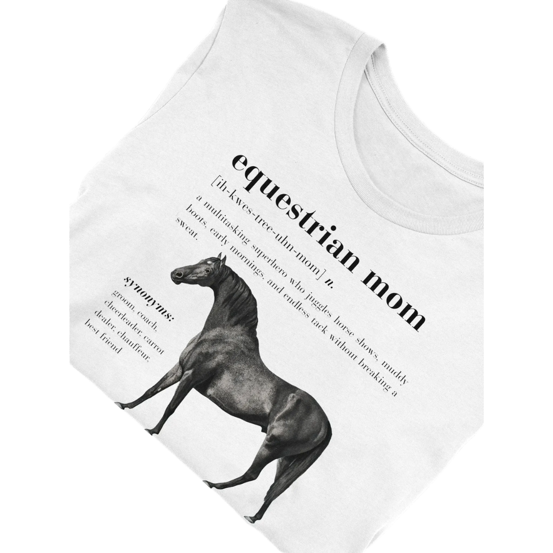 White folded crew neck t-shirt with the definition of 'equestrian mom' printed on the front, featuring an image of a horse.