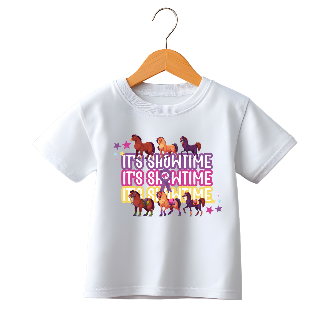 White t-shirt with colorful horse graphics and 'It's Showtime' text on a hanger against a white background