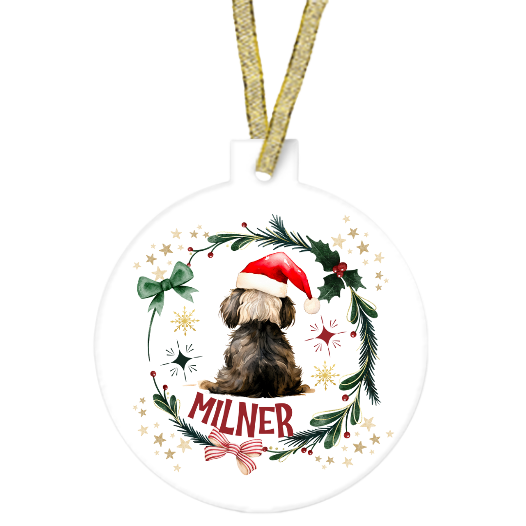 Christmas ornament with a dog wearing a Santa hat and the name 'Milner'.